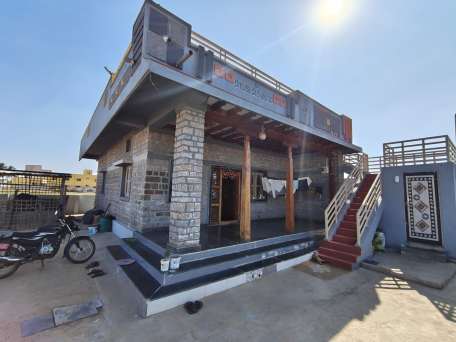 Completed residential house with stone-clad frontage and covered parking